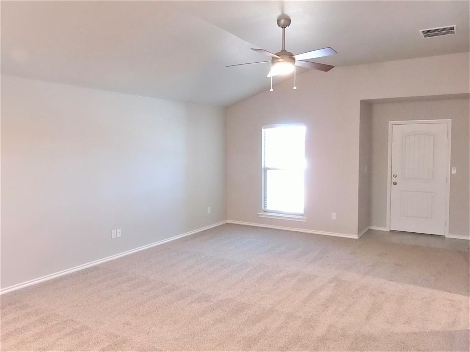 3712 Prentiss Avenue Lubbock, TX 79407 - Photo 5 of 23 an empty room with a window and chandelier fan