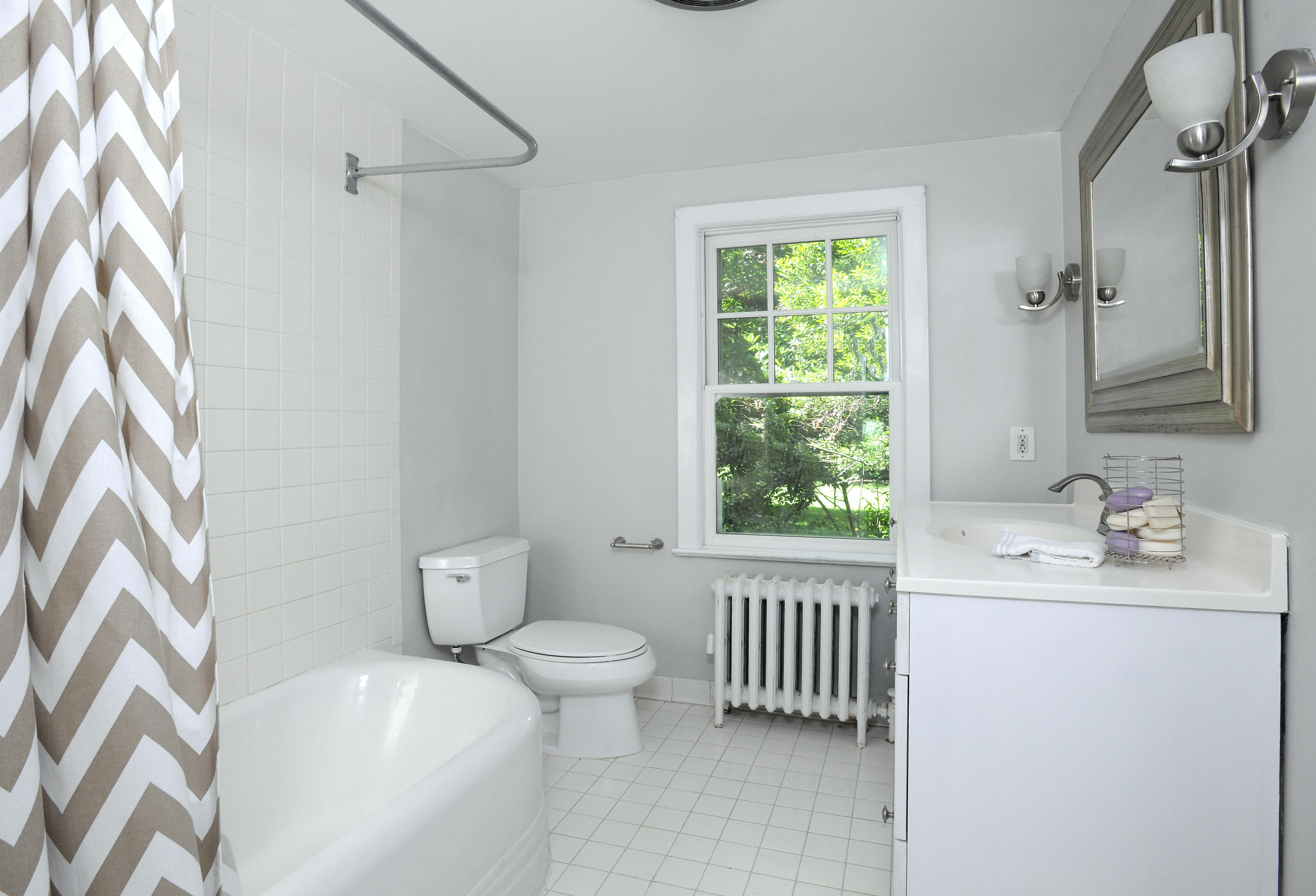 58 Locust Hill Road Darien, CT 06820 - Photo 11 of 21 a bathroom with a sink toilet a mirror and window