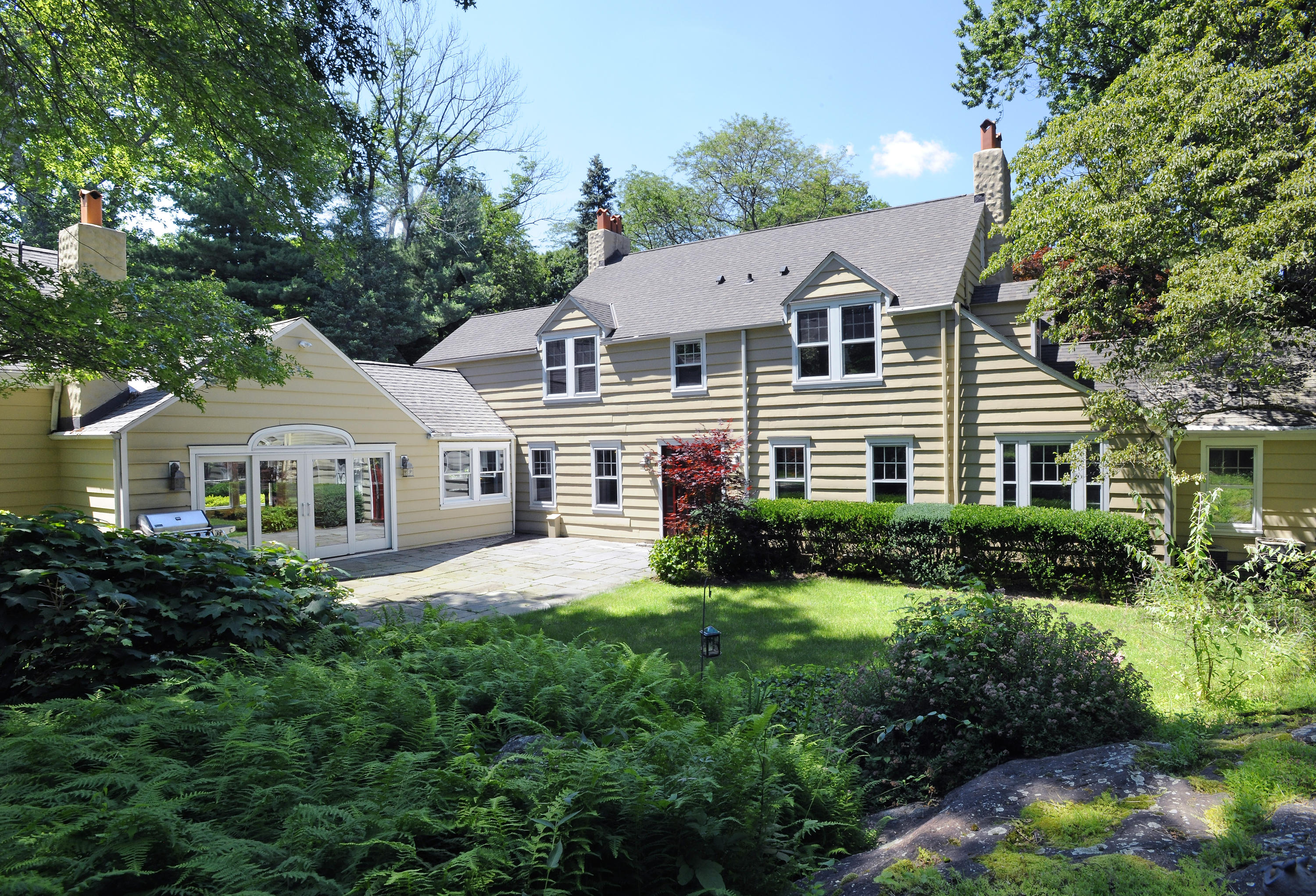 58 Locust Hill Road Darien, CT 06820 - Photo 17 of 21 a view of a white house next to a yard with plants and trees