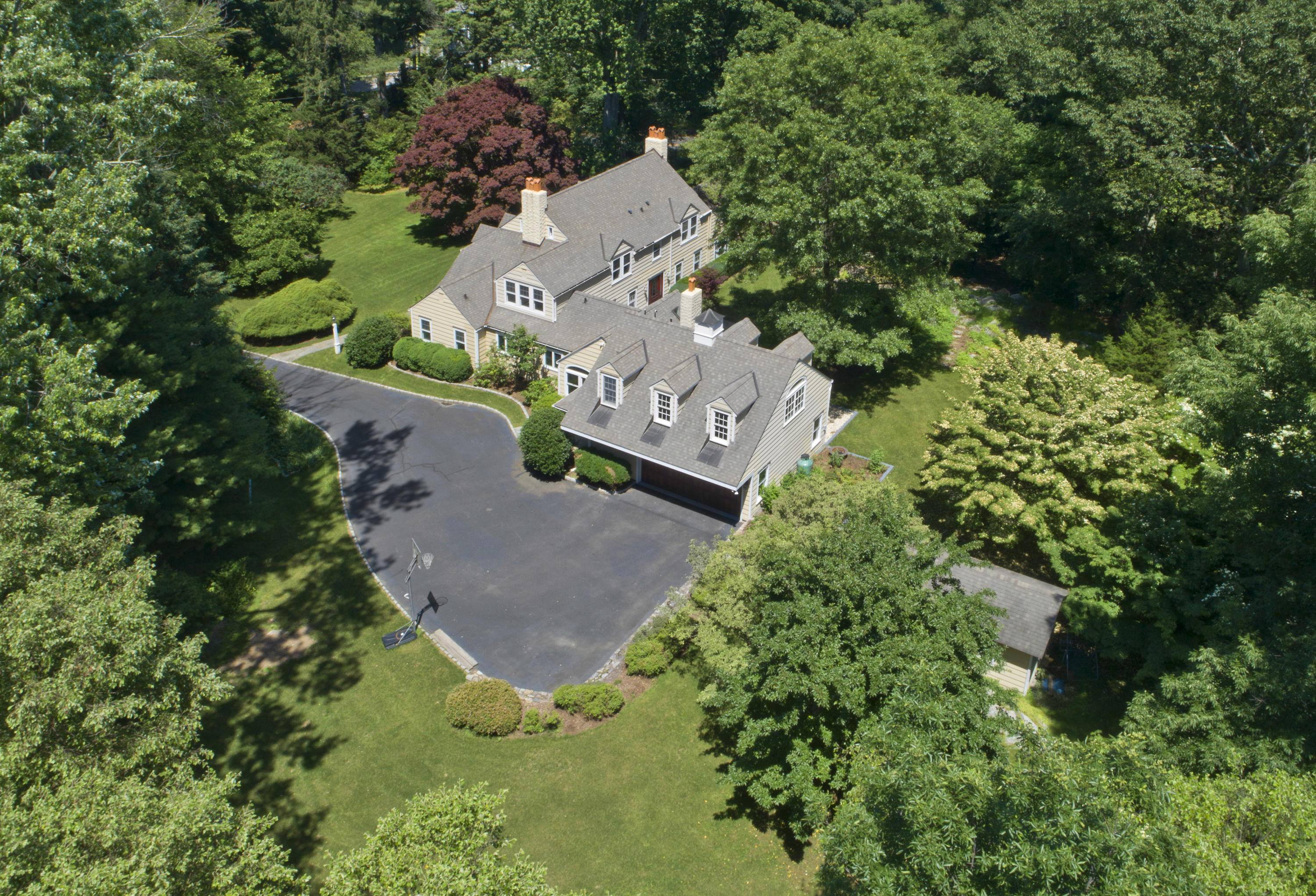 58 Locust Hill Road Darien, CT 06820 - Photo 18 of 21 an aerial view of a house with a yard and trees