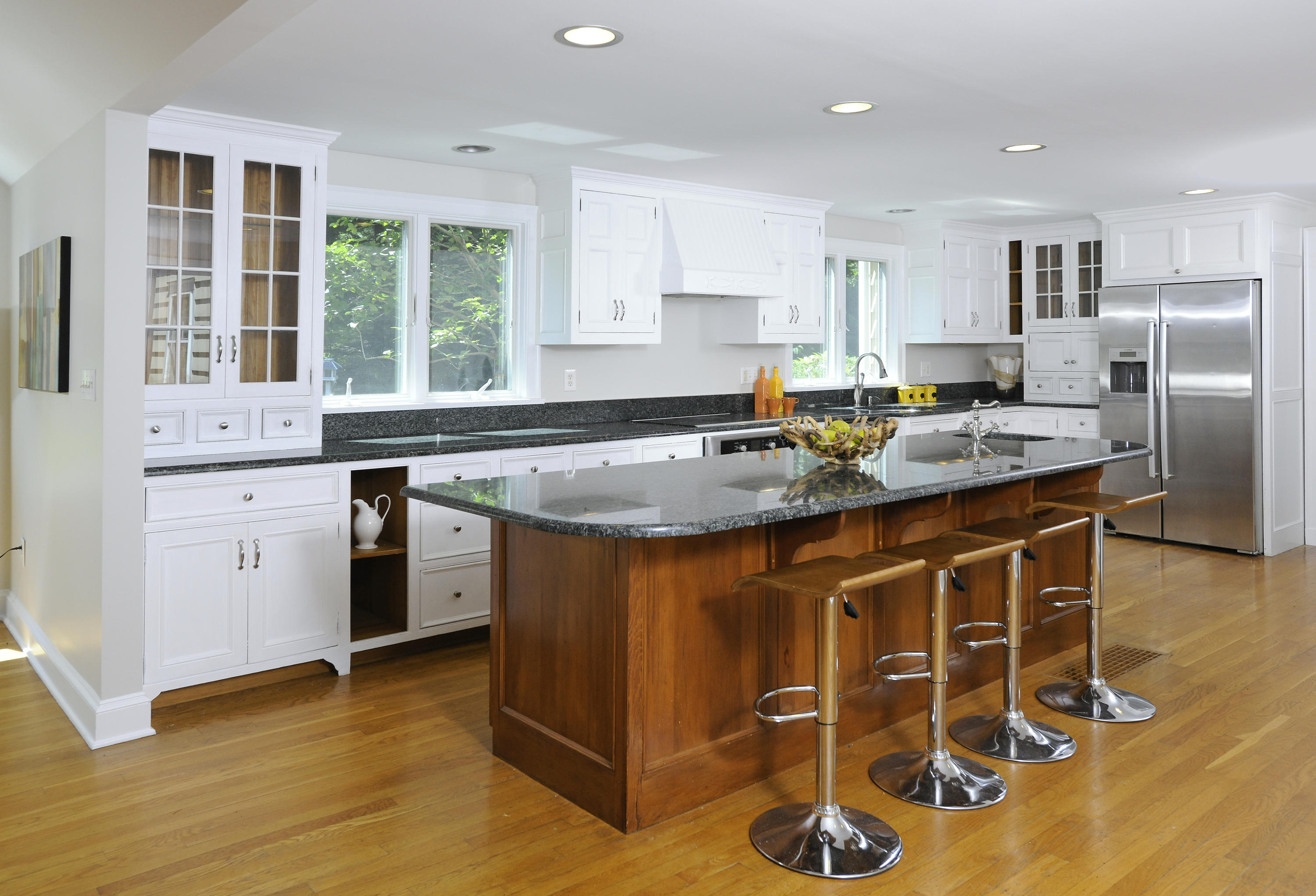 58 Locust Hill Road Darien, CT 06820 - Photo 9 of 21 a kitchen with stainless steel appliances granite countertop a stove a sink a refrigerator white cabinets with wooden floor