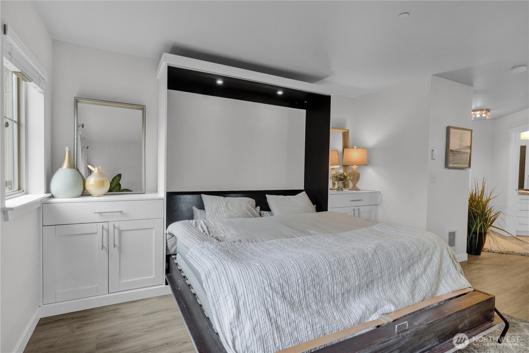 1125 East Olive Street, Unit 212 Seattle, WA 98122 - Photo 11 of 39 a bedroom with a bed and a potted plant