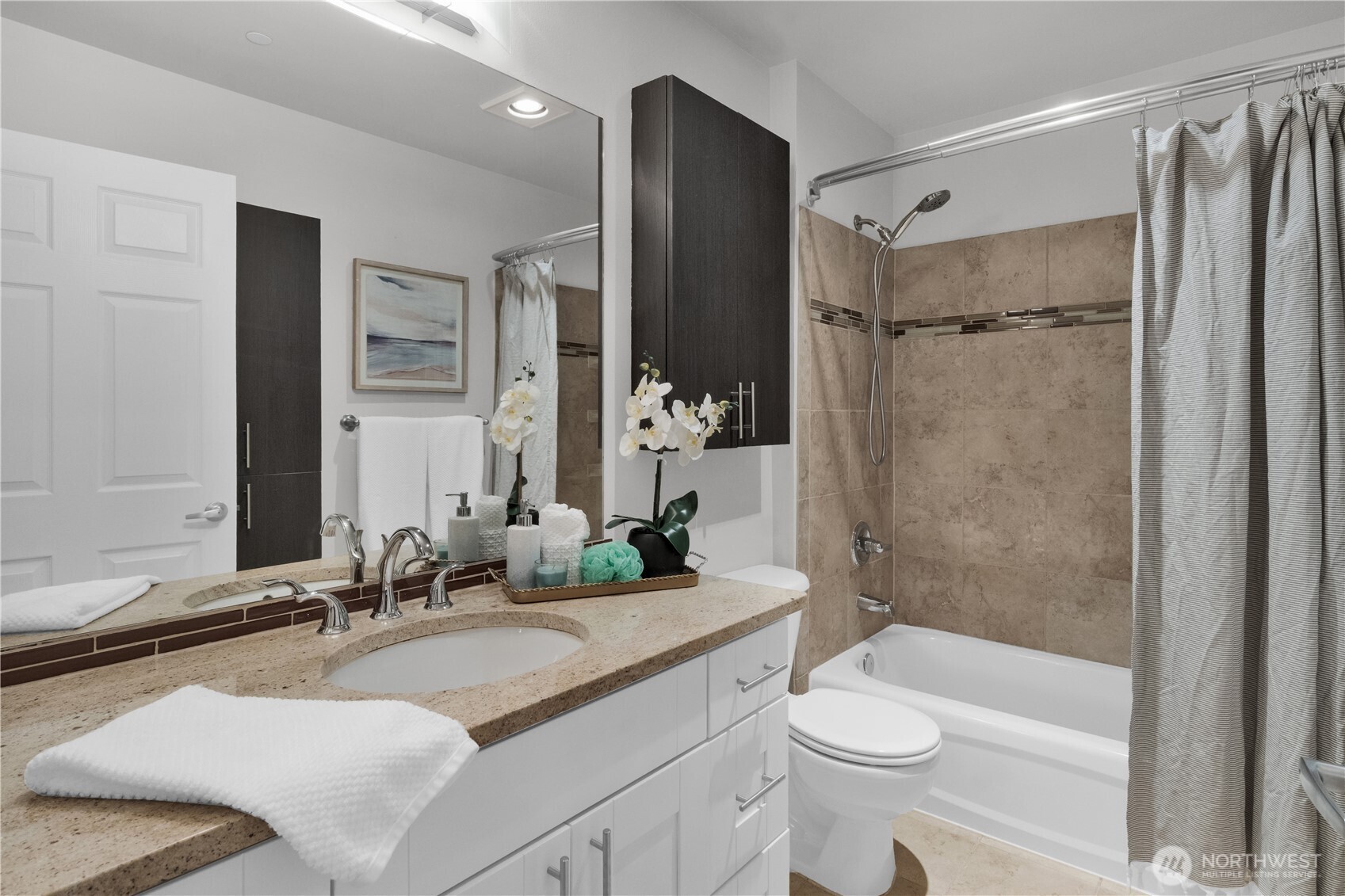 1125 East Olive Street, Unit 212 Seattle, WA 98122 - Photo 14 of 39 a bathroom with a double vanity sink toilet mirror and shower