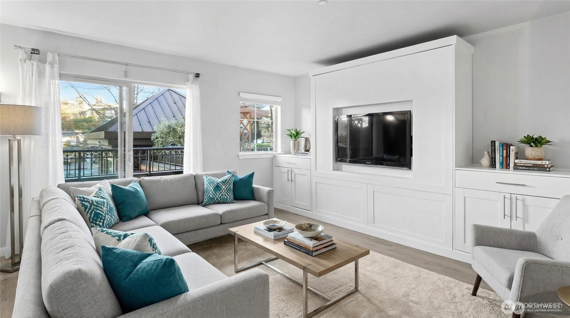 1125 East Olive Street, Unit 212 Seattle, WA 98122 - Photo 3 of 39 a living room with furniture and a flat screen tv
