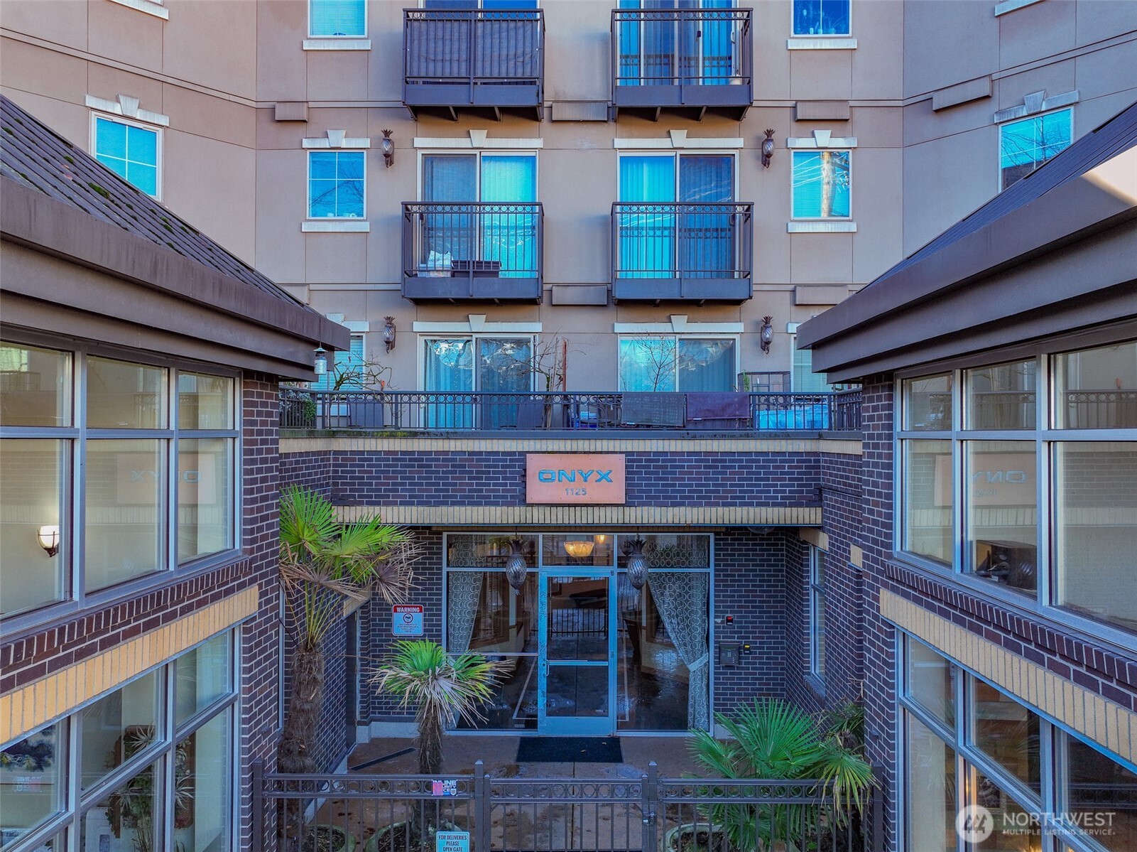 1125 East Olive Street, Unit 212 Seattle, WA 98122 - Photo 32 of 39 a front view of a building with a garden