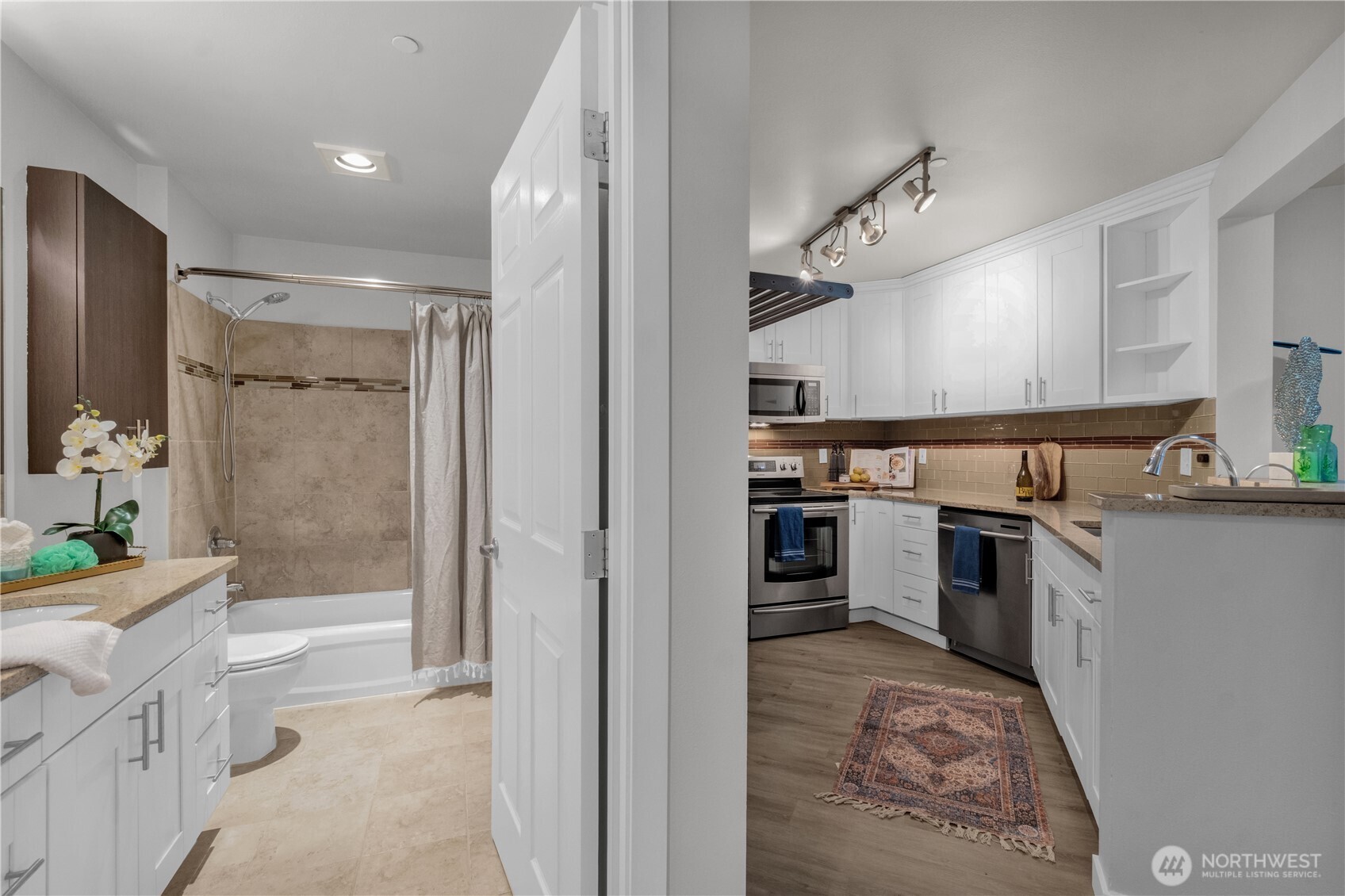 1125 East Olive Street, Unit 212 Seattle, WA 98122 - Photo 6 of 39 a bathroom with a granite countertop sink a toilet and shower