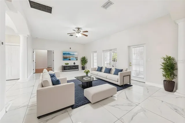 a living room with furniture and wooden floor