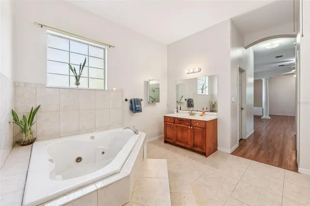 a bathroom with a sink a mirror and shower