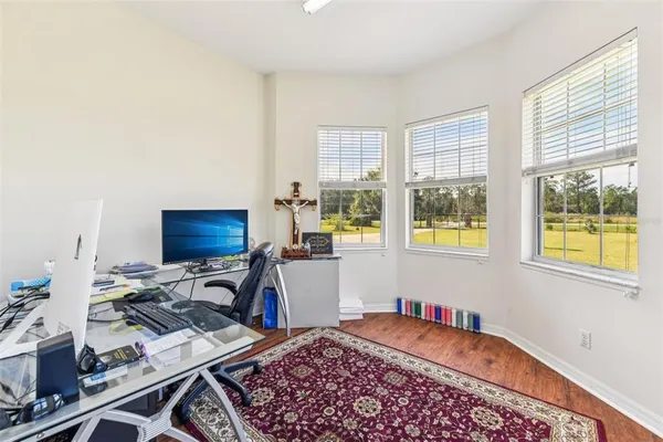 a view of a kitchen with wooden floor and a chandelier