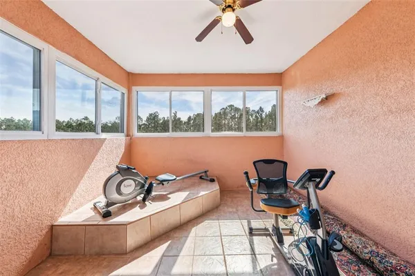 a bathroom with a toilet a sink a mirror and a window