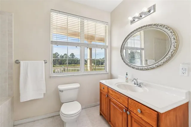 a white bath tub sitting next to a white sink and vanity