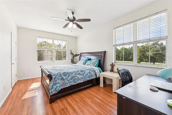 a bedroom with a bed and a desk