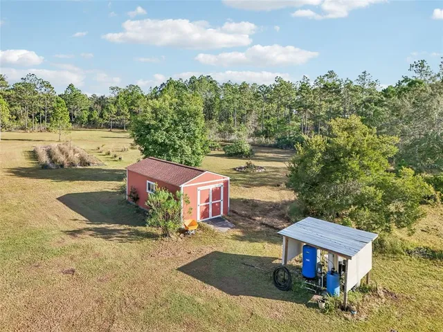 an aerial view of a houses with a yard