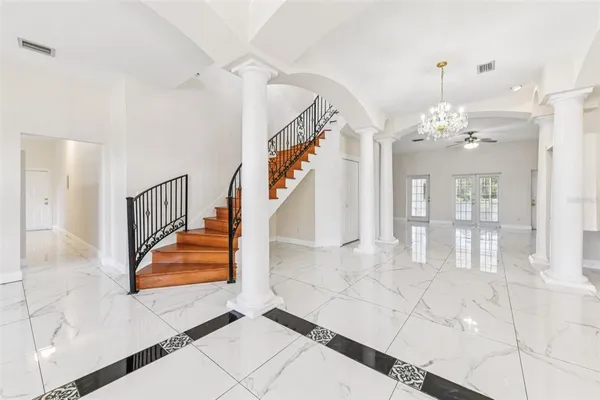 a view of a dining room with furniture and chandelier