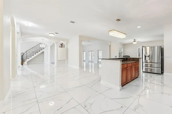 a view of kitchen with stainless steel appliances granite countertop a stove and a refrigerator