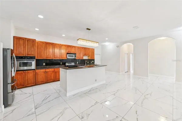 a kitchen with stainless steel appliances granite countertop a sink and a stove