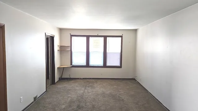 an empty room with a empty space and window