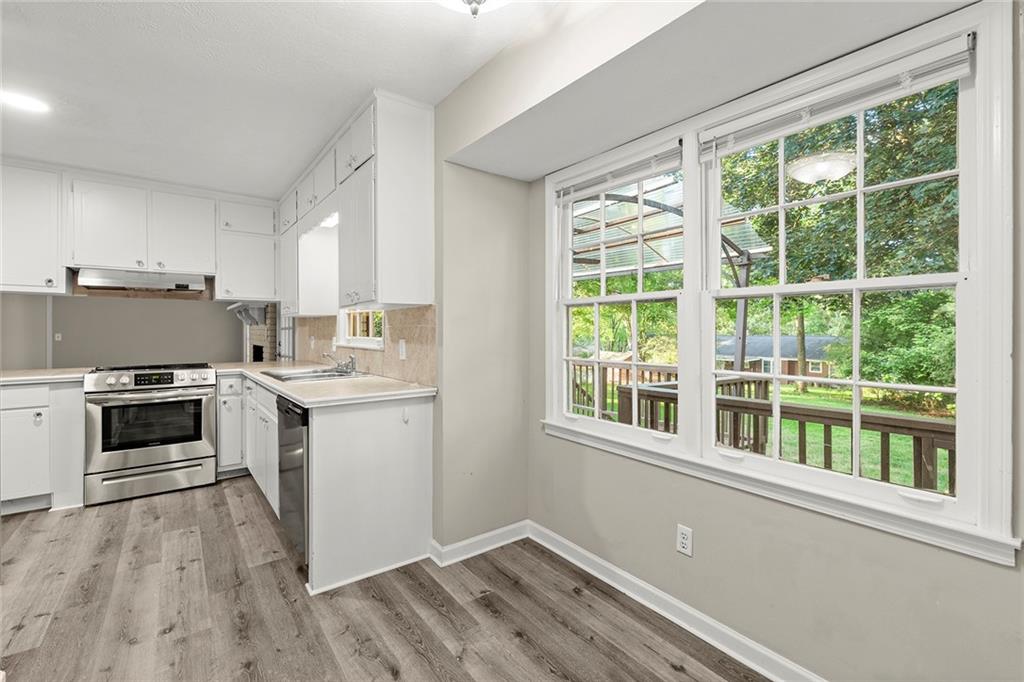 410 Milton Avenue Alpharetta, GA 30009 - Photo 11 of 42 a kitchen with a stove a sink and a window
