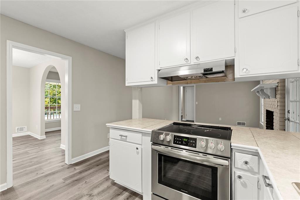 410 Milton Avenue Alpharetta, GA 30009 - Photo 14 of 42 a kitchen with a stove and a microwave