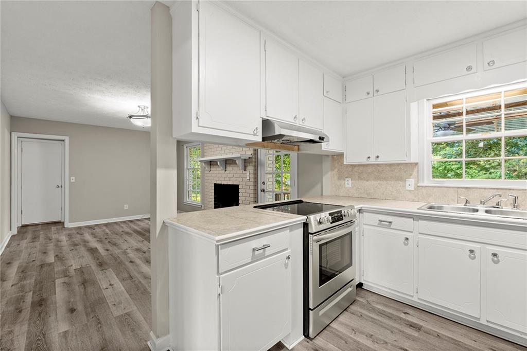 410 Milton Avenue Alpharetta, GA 30009 - Photo 15 of 42 a kitchen with a stove a sink and a microwave