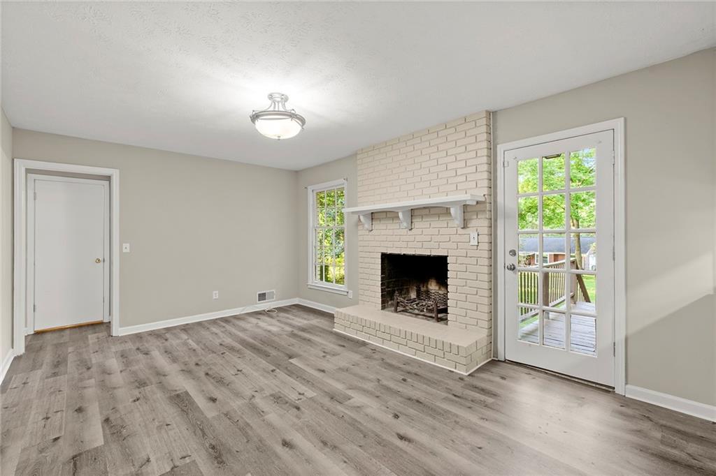 410 Milton Avenue Alpharetta, GA 30009 - Photo 16 of 42 a view of an empty room with a fireplace and a window