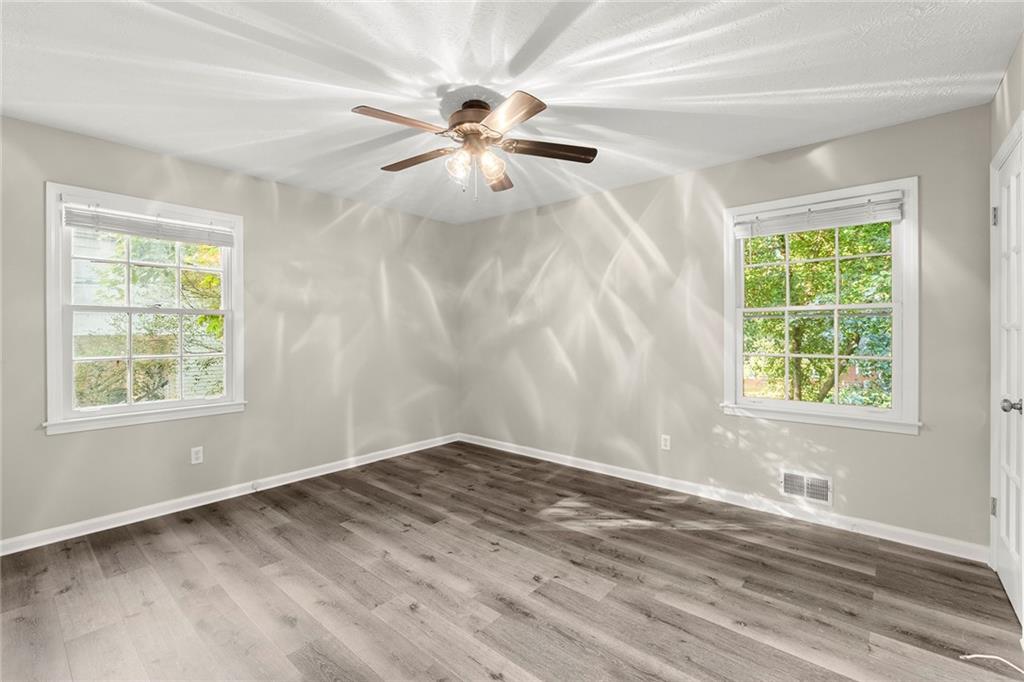 410 Milton Avenue Alpharetta, GA 30009 - Photo 20 of 42 a view of an empty room with wooden floor and a window