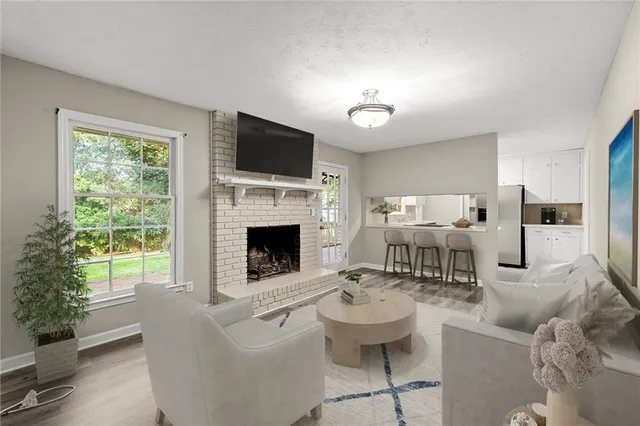 a living room with furniture a fireplace and a flat screen tv
