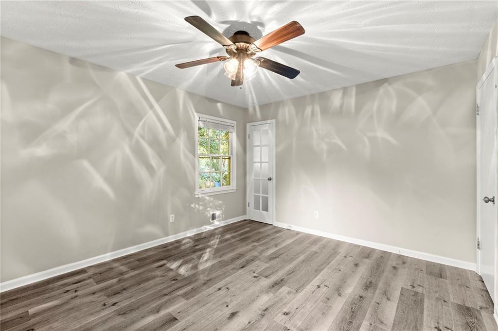 410 Milton Avenue Alpharetta, GA 30009 - Photo 21 of 42 an empty room with windows and fan