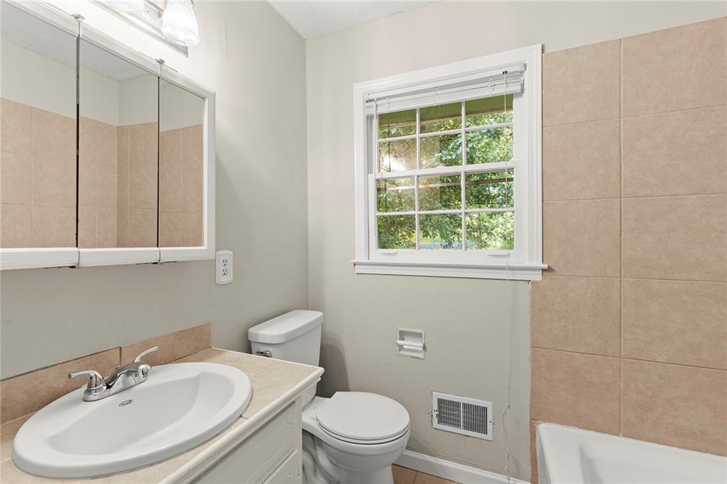 410 Milton Avenue Alpharetta, GA 30009 - Photo 23 of 42 a bathroom with a sink a toilet and a mirror