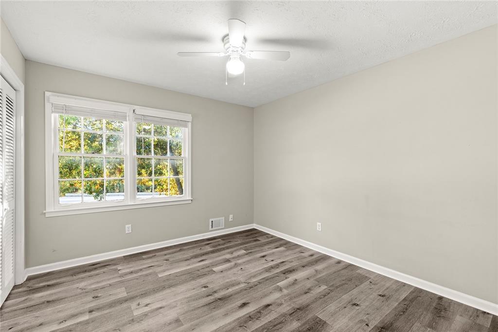 410 Milton Avenue Alpharetta, GA 30009 - Photo 24 of 42 an empty room with wooden floor and windows