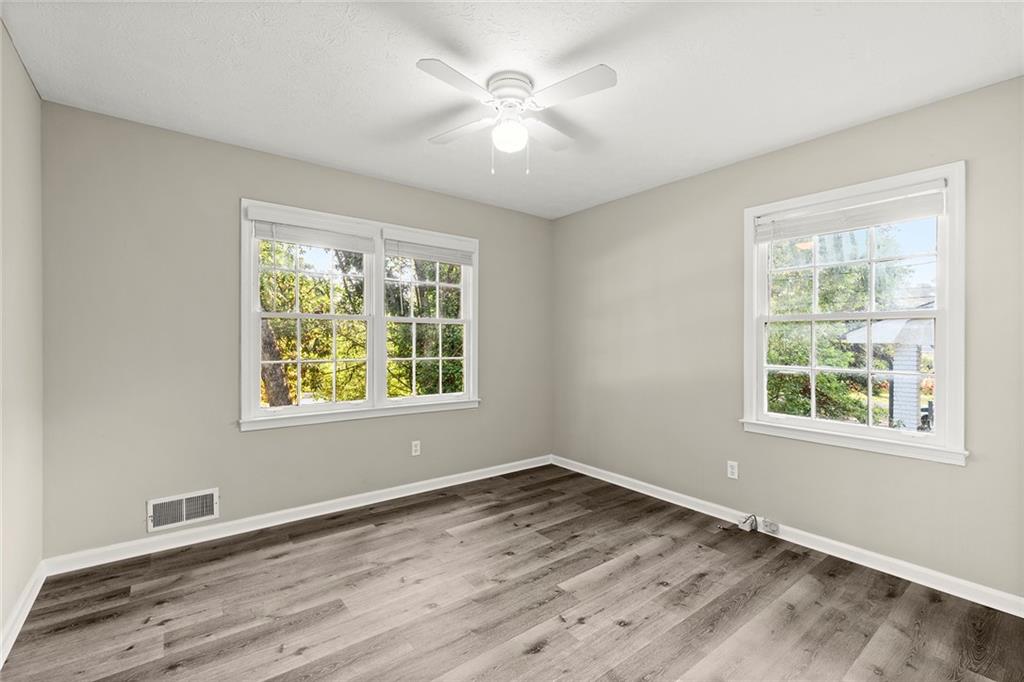 410 Milton Avenue Alpharetta, GA 30009 - Photo 27 of 42 an empty room with wooden floor and windows