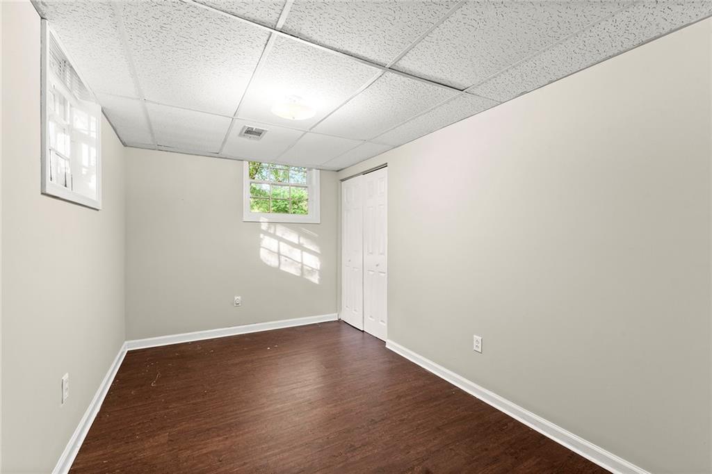 410 Milton Avenue Alpharetta, GA 30009 - Photo 29 of 42 an empty room with wooden floor and windows