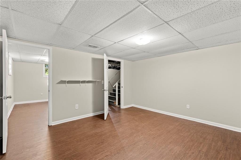 410 Milton Avenue Alpharetta, GA 30009 - Photo 30 of 42 an empty room with wooden floor cabinet and windows