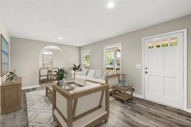 a living room with furniture and wooden floor