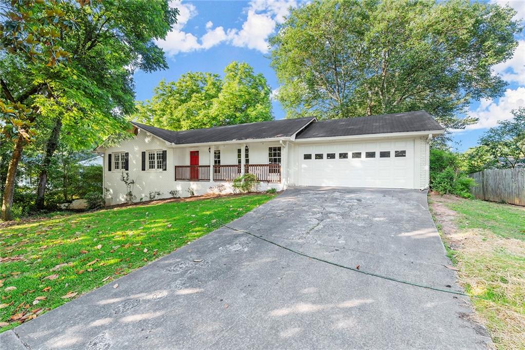 410 Milton Avenue Alpharetta, GA 30009 - Photo 34 of 42 a front view of a house with a yard and green space