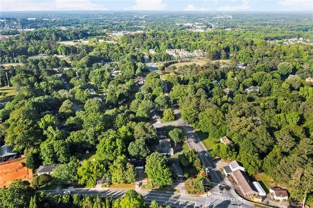 an aerial view of a houses with a yard