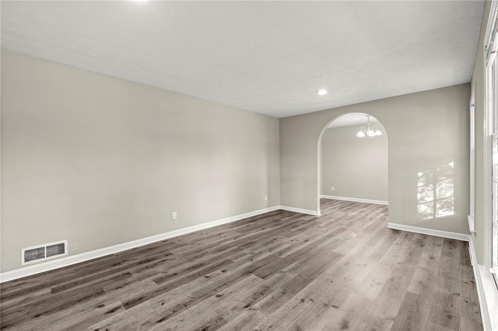 410 Milton Avenue Alpharetta, GA 30009 - Photo 6 of 42 a view of an empty room with wooden floor and a window
