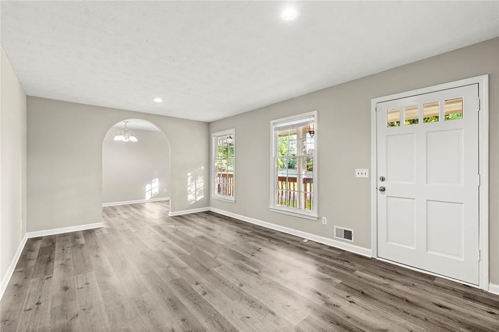 410 Milton Avenue Alpharetta, GA 30009 - Photo 7 of 42 a view of an empty room with wooden floor and a window