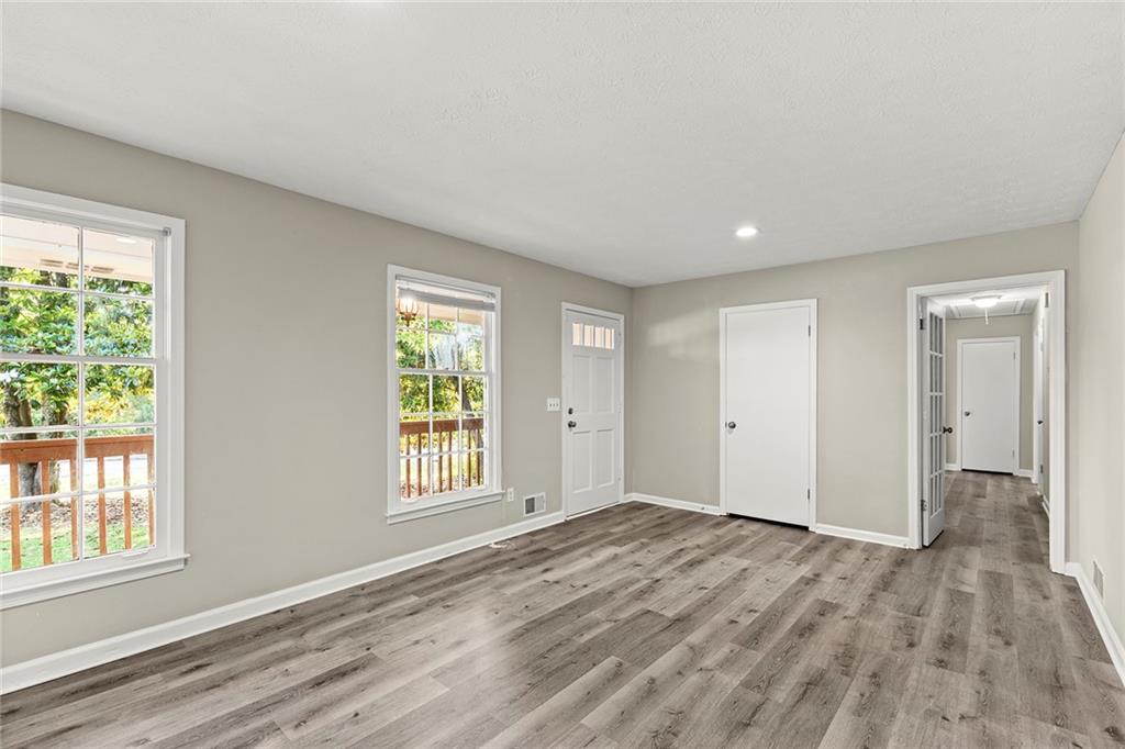 410 Milton Avenue Alpharetta, GA 30009 - Photo 8 of 42 a view of an empty room with wooden floor and a window