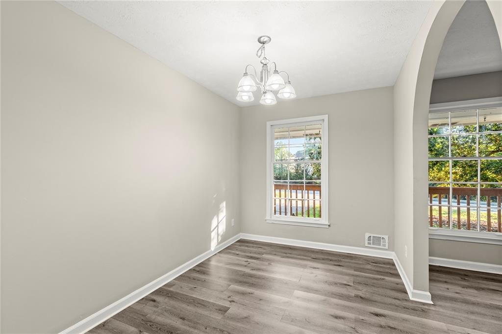 410 Milton Avenue Alpharetta, GA 30009 - Photo 10 of 42 a view of an empty room with wooden floor and a window
