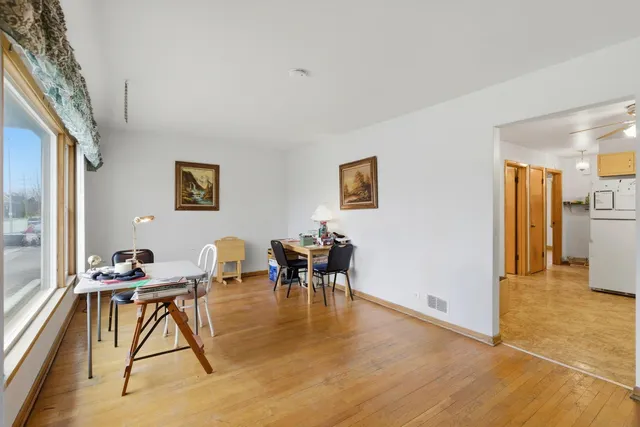 a dining room with furniture and a kitchen view