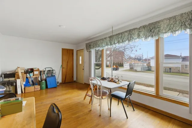 a dining room with furniture and a floor to ceiling window