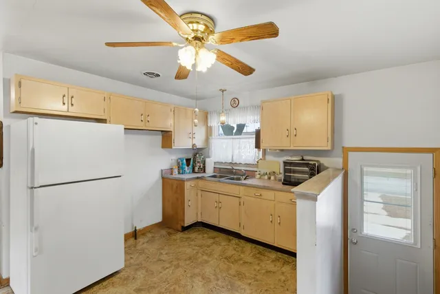 a kitchen with stainless steel appliances a refrigerator a sink and a stove