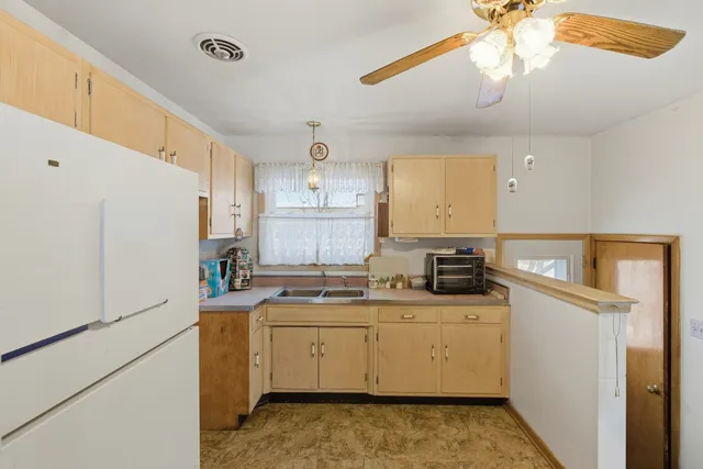 a utility room with cabinets washer and dryer