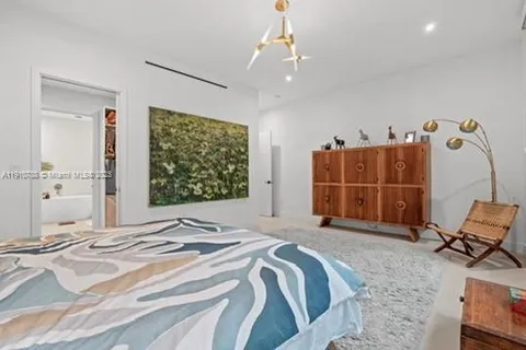 a white bath tub sitting next to a toilet