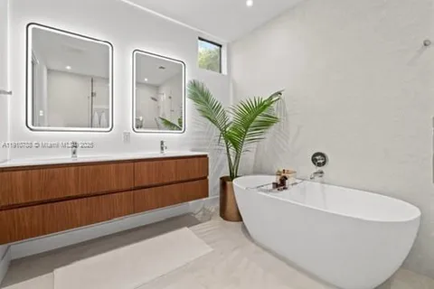 a white bath tub sitting next to a bathroom