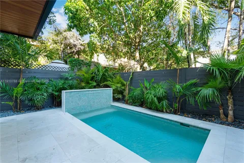 front view of a house with potted plants