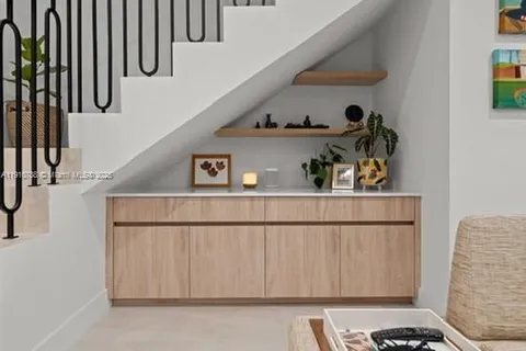 a kitchen with a table chairs stove and cabinets