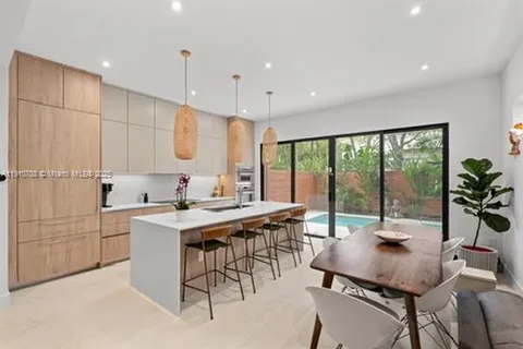 a living room with kitchen island furniture and a wooden floor