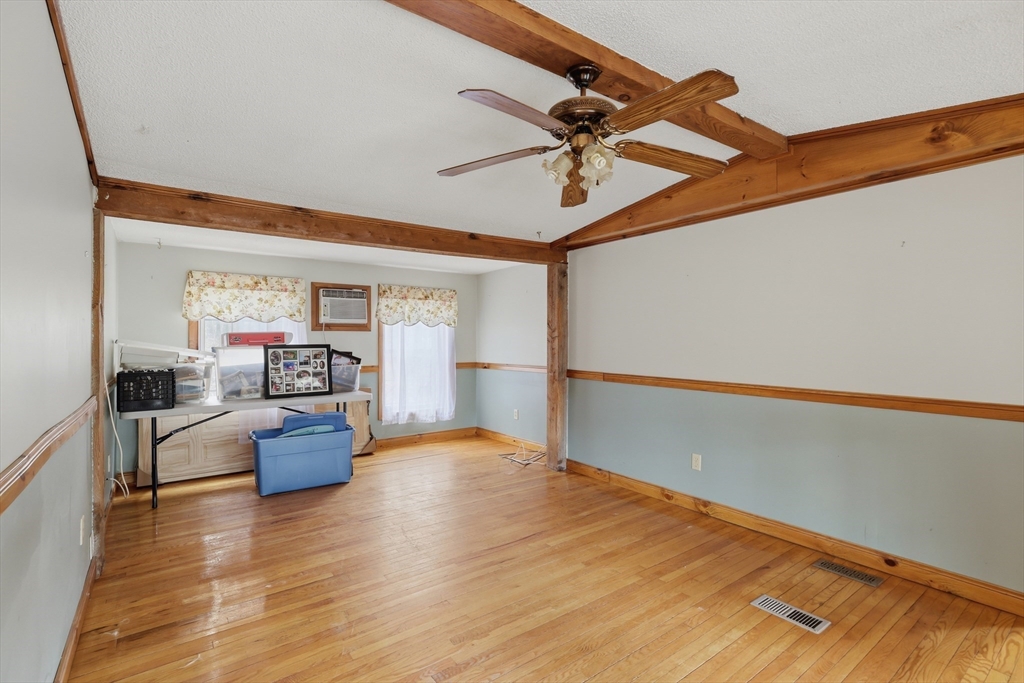 987 Patriots Road Templeton, MA 01468 - Photo 11 of 39 a view of a workspace with wooden floor and a ceiling fan